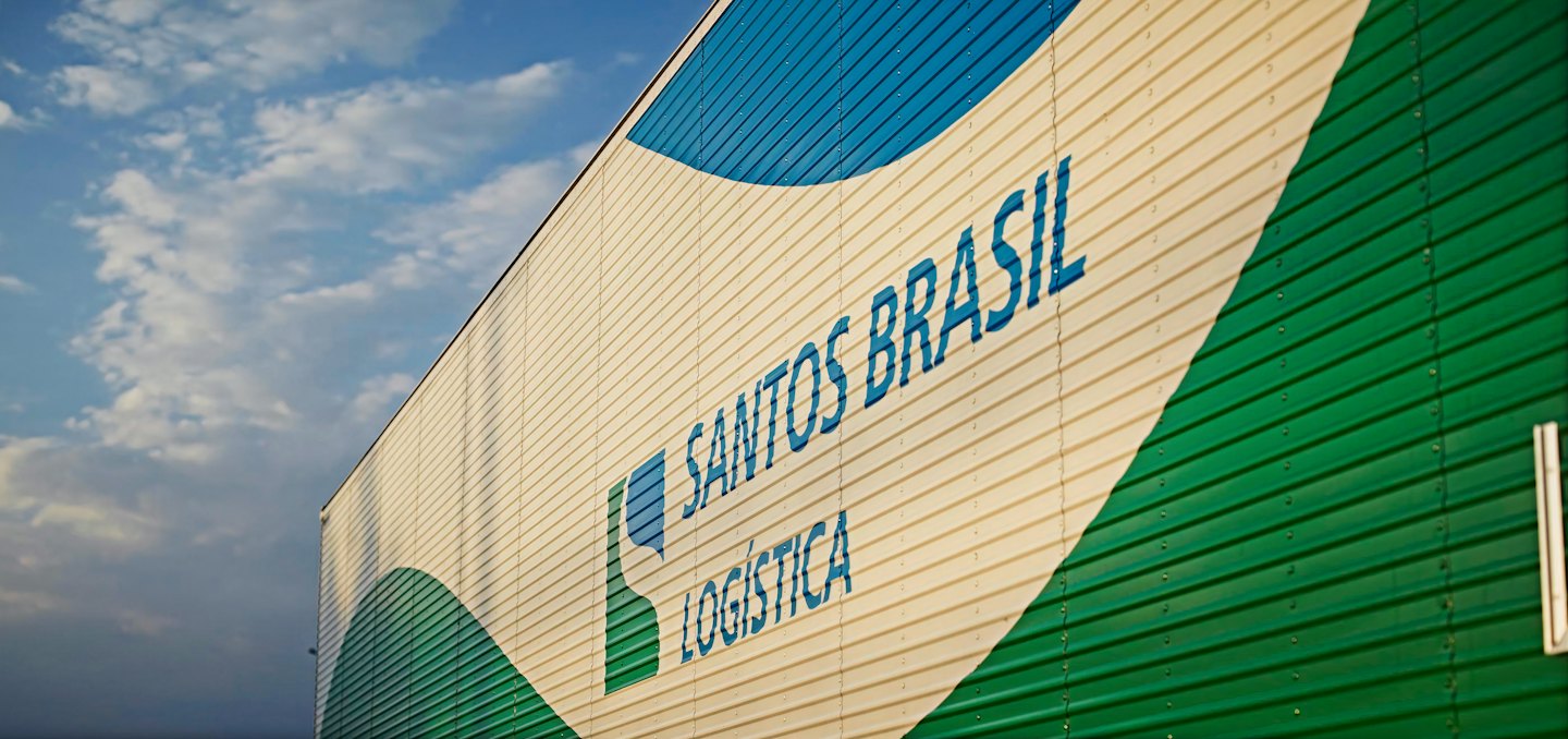 Santos Brasil Logistica corporate branding on a metal industrial building.